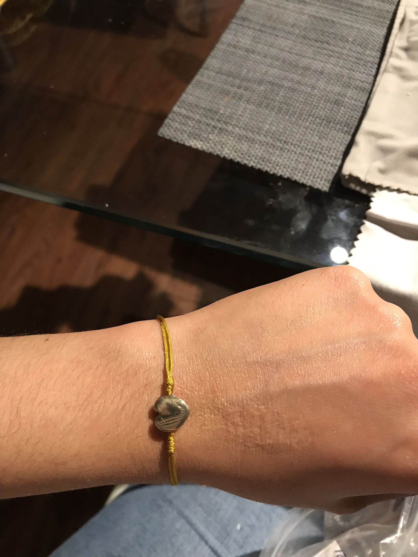 Bracelet in thread with 18k gold charms