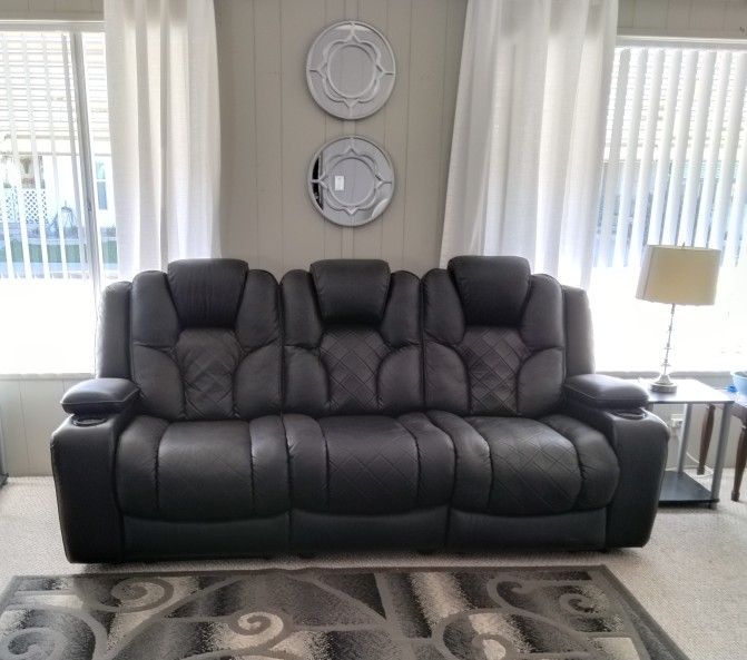 Black Couch 7-1/2 Ft. Reclines & has entertainment features,