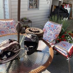 Two helmets and a pair of wheels