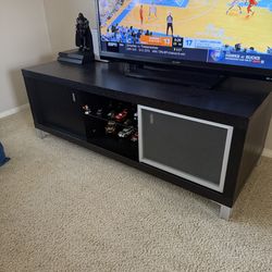 TV Stand black color 2 open door storage & one center glass shelf with privacy glass slide.