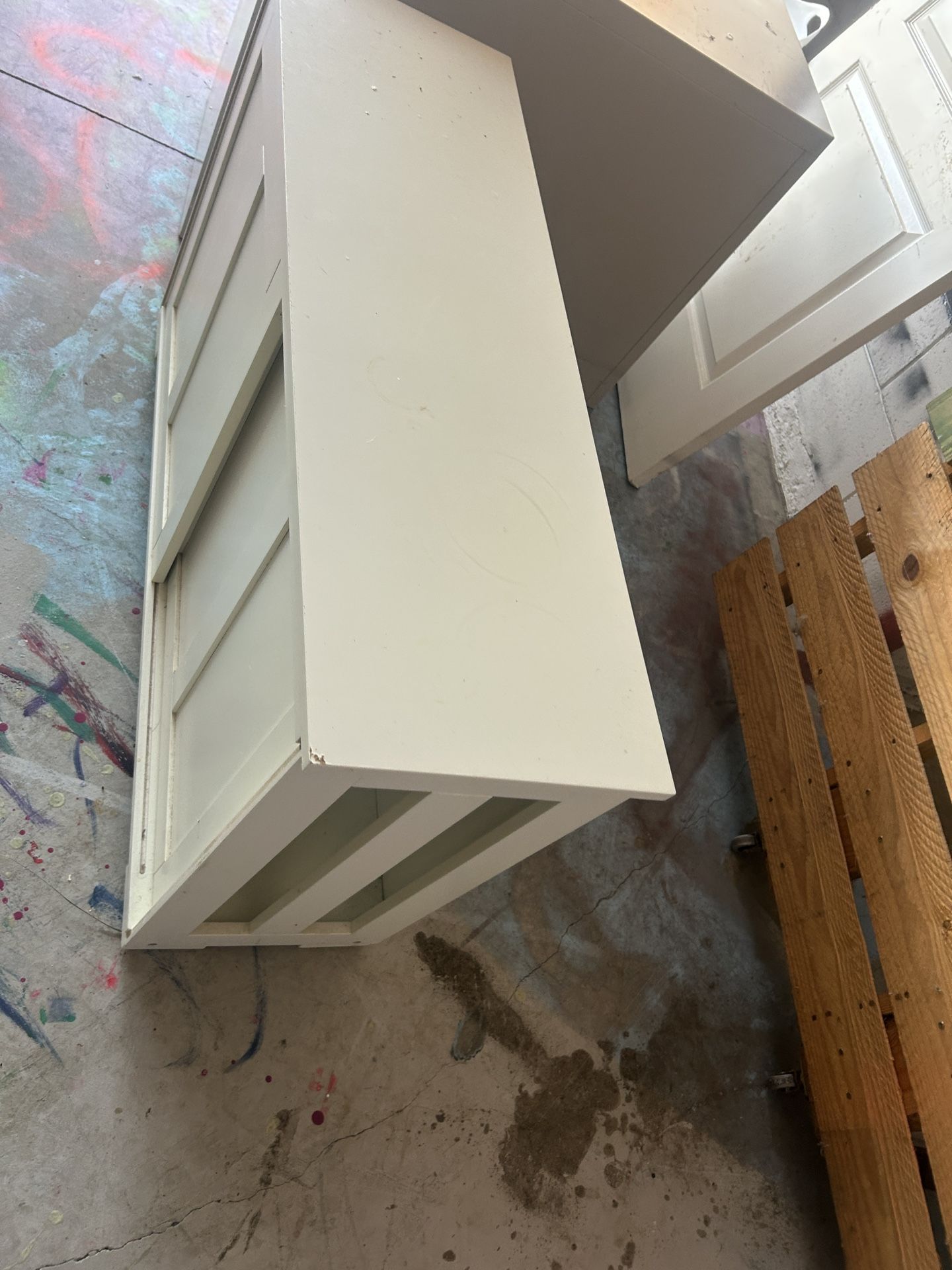 Sturdy white storage console table with cabinet-style paneling. Heavy, solid construction — not IKEA-quality.