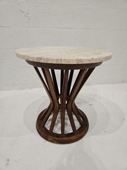 Round travertine coffee table by Edward Wormley