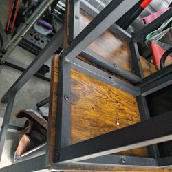 Bar Table W/ 2 Stools & A Weight Machine In Back