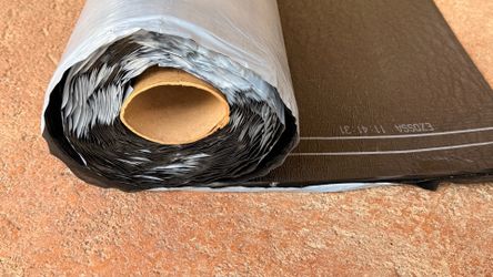 Self adhering base sheet roll