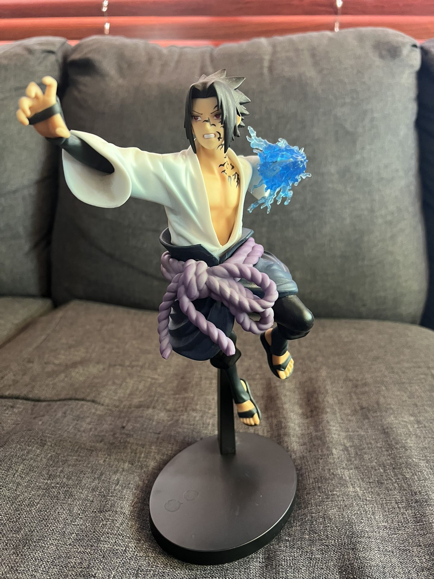 Sasuke Uchiha action figure from the Naruto anime series.