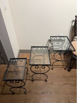 3 different sized glass tables