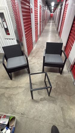 Patio chairs and table with glass