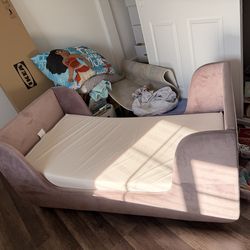 Pink upholstered toddler bed