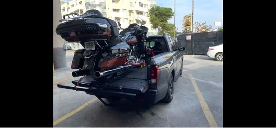 Custom made truck bed extender for motorcycle