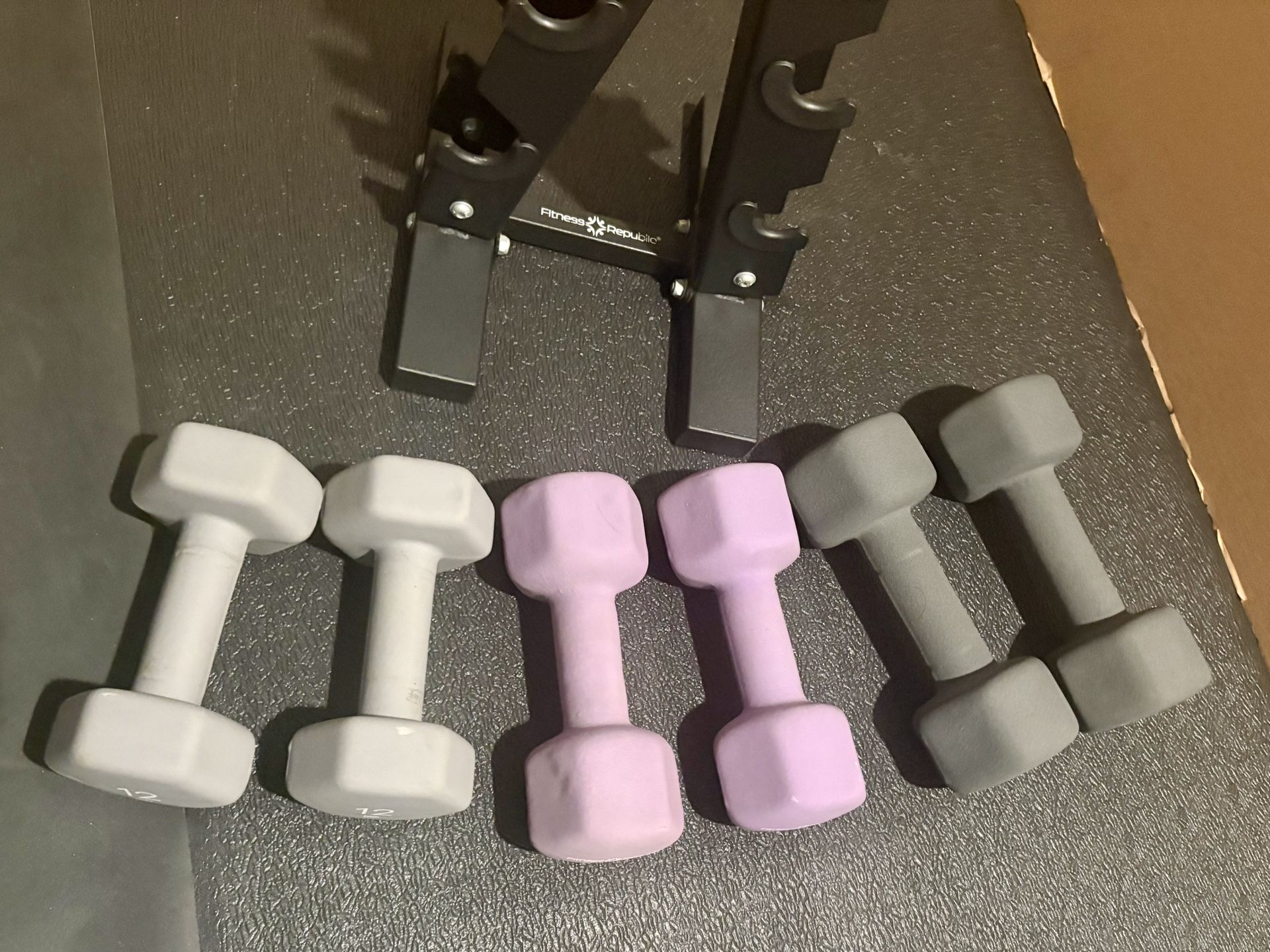 Cast Iron Neoprene Coat ...Set of Dumbbells with Rack; pairs of 12s, 15s and 17.5 lbs.