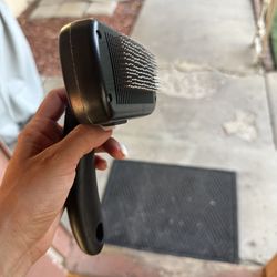 Self cleaning dog and cat brush