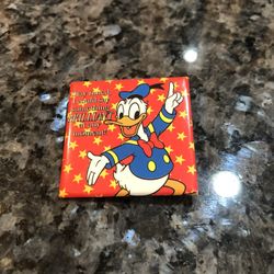 Vintage Disney Donald Duck Pin Back Pin.  Square shape.  Size 1 1/2 inches by 1 1/2 inches.  Written in the pin “Stay tuned I could say something BRIL