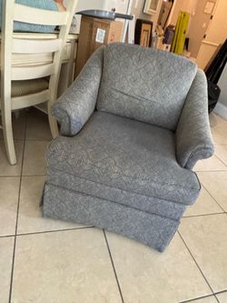Upholstered skirted arm chair
