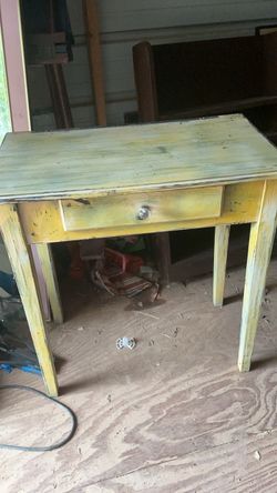 Distressed Yellow Wooden Desk with Single Drawer it’s 30 inches tall 28 inches wide and 13 deep