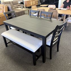 Dining table with chairs and a bench