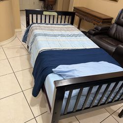Twin bed, mattress, sheet and comforter.