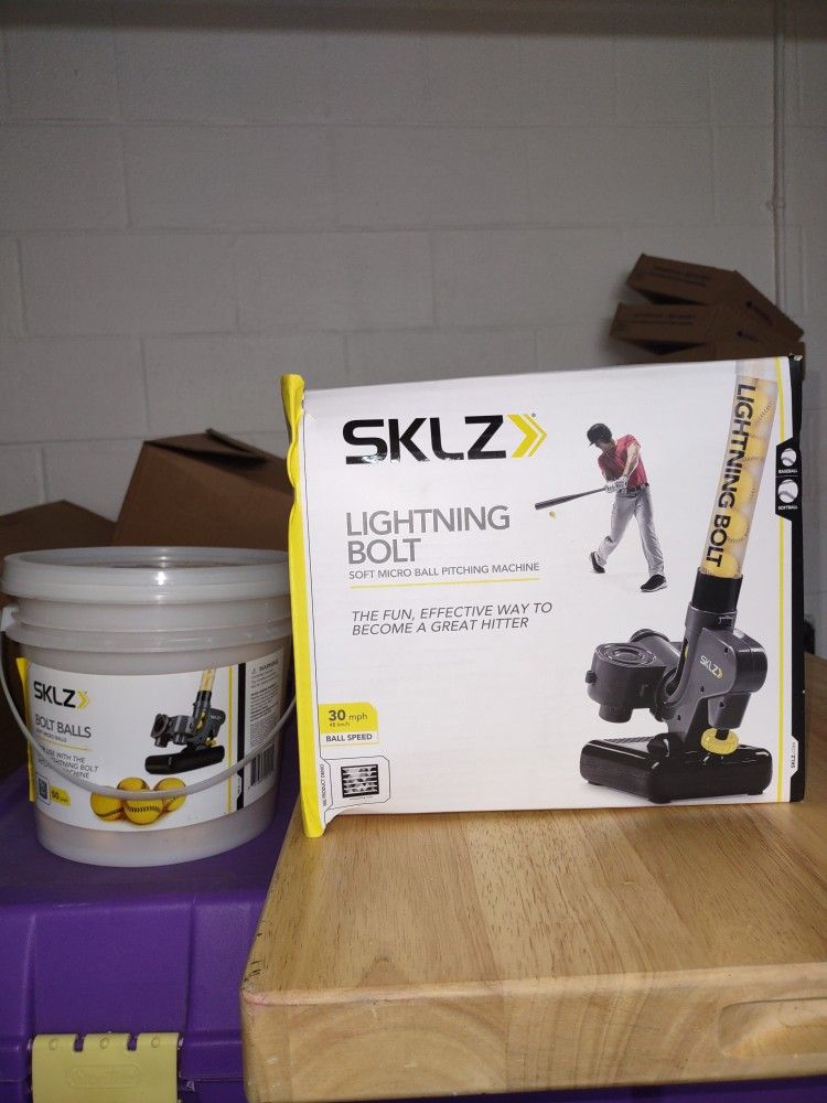 Sklz Lightning Bolt Softball Pitching Machine With A Bucket Of Balls