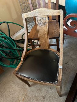 2 antique wood and leather chairs
