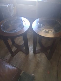Wood End tables with glass tops .