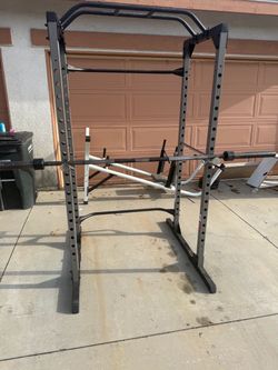 Very nice and strong squat rack with 7 ft Olympic bar. Perfect for squats, bench press, and pull ups. $300