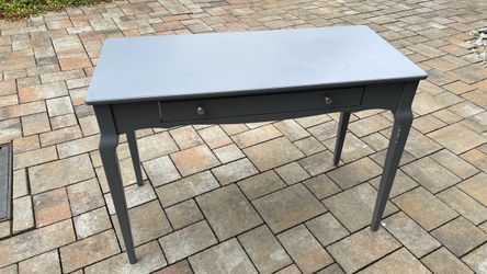 Narrow wooden desk with pencil drawer