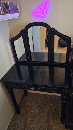 Black vanity with classic tri-fold mirror