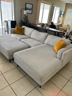 Beautiful sectional couch with matching large Ottoman from living Spaces