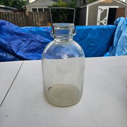.vintage or antique glass carboy, jug, or jar produced by the historic British firm J. Reynolds & Sons, which operated out of Bristol, England. These 