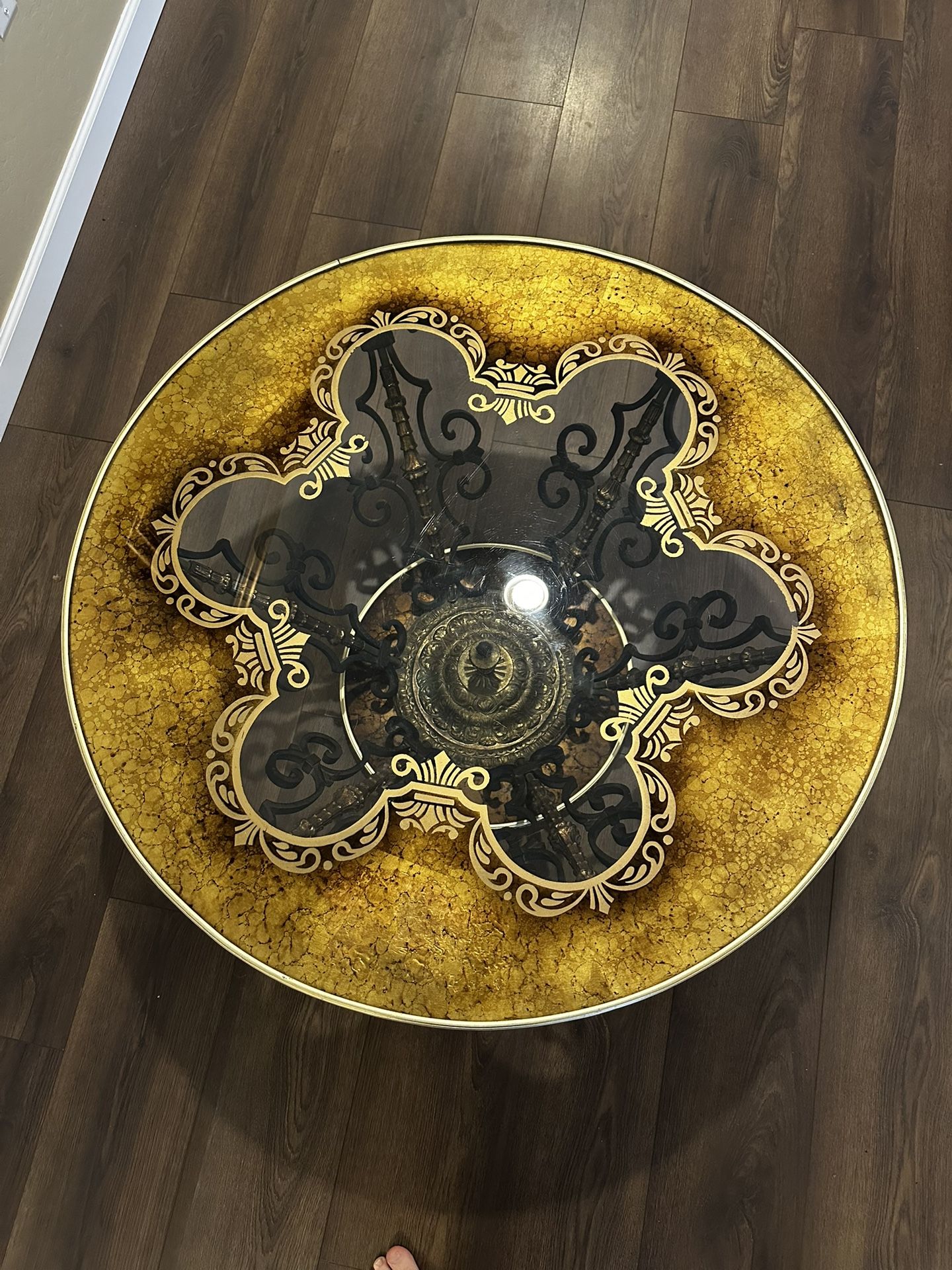 Vintage Hollywood Regency ornate glass-top coffee table with a metal and brass/gilt base