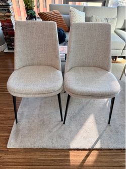 Two mid-century inspired dining chairs