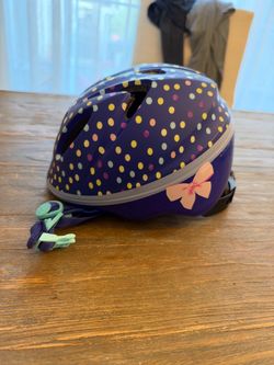 Schwinn kids’ helmet in purple with colorful polka dots