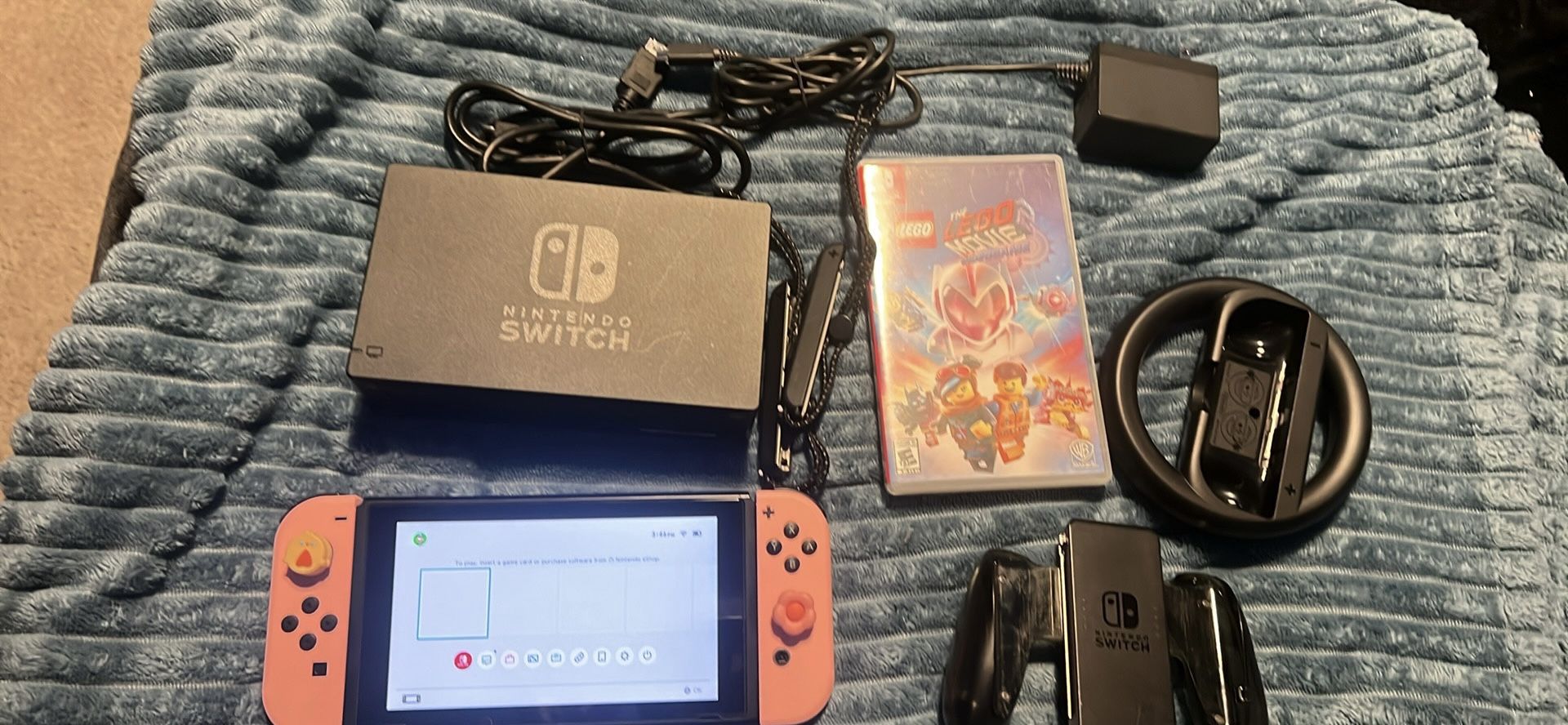 Nintendo switch with docking station, steering wheel, joy, con, grip, and, the Lego movie game
