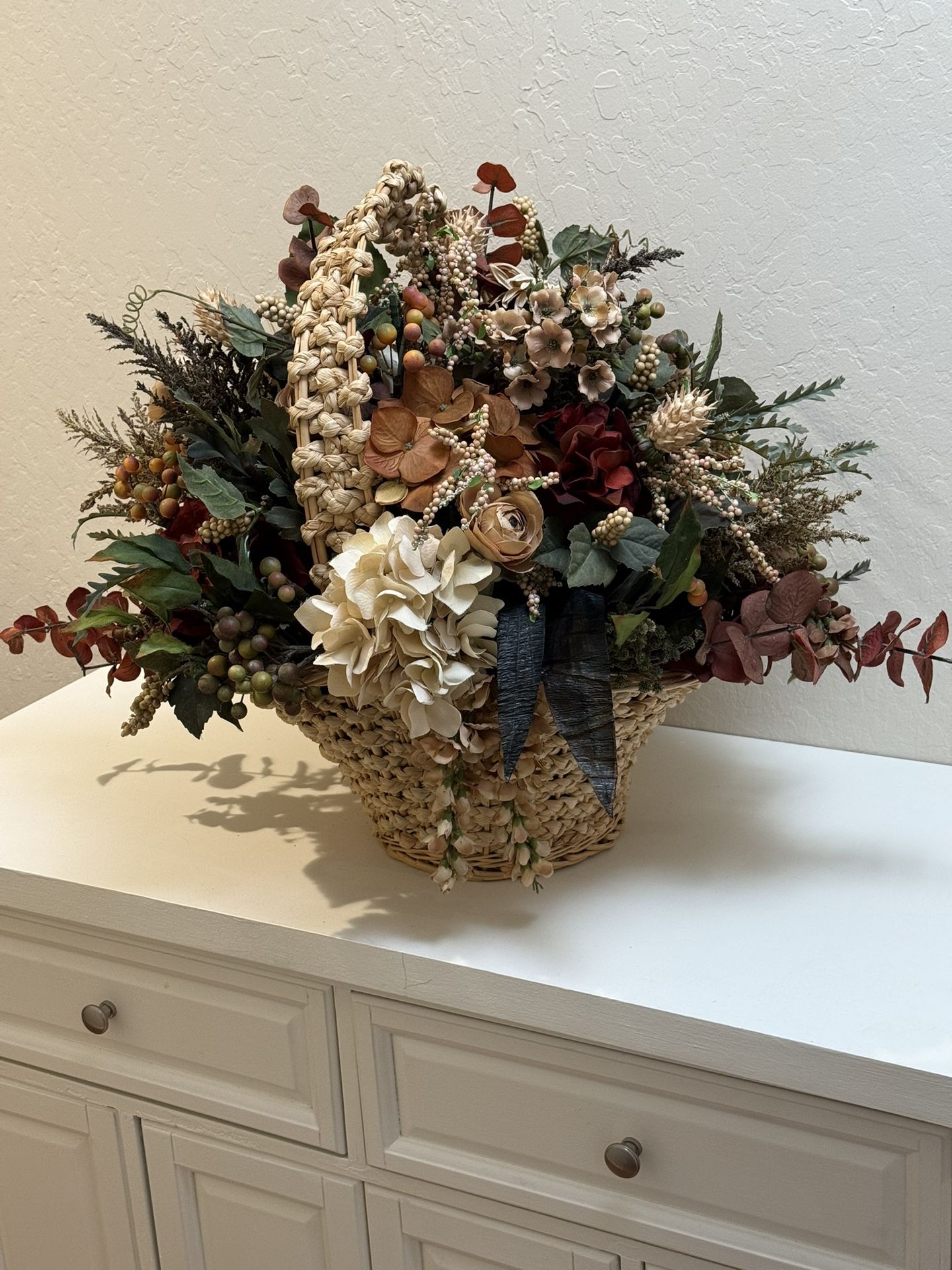 Large Floral Arrangement In A Basket.