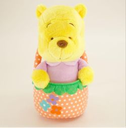 Disney Winnie the Pooh Easter Plush seated inside a polka-dot basket