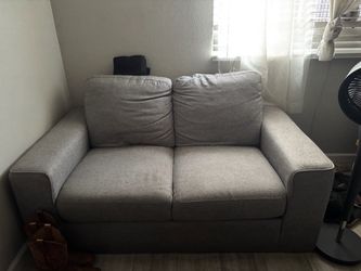 Grey couch with foot rest