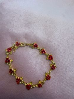Gold bracelet with red roses