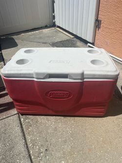Cooler for keeping things cold; it has a small scratch on the outside, but the inside is in good condition. It measures 26 inches long, 14 inches wide