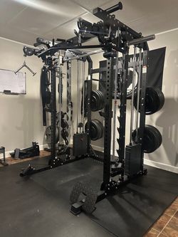 Smith machine squat rack home gym dumbbells kettlebells rubber flooring bench bar leg press weights bumper plates