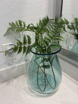 Beautiful glass vase with greenery