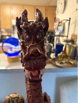 Hand carved wooden Dragon statue with the globe of the earth
