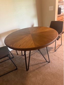 Brown round table with 2 chairs