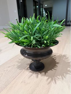 Vase with fake green plants