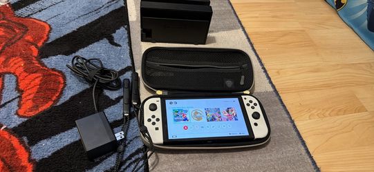 Nintendo switch OLED with docking station, charger, and wrist straps
