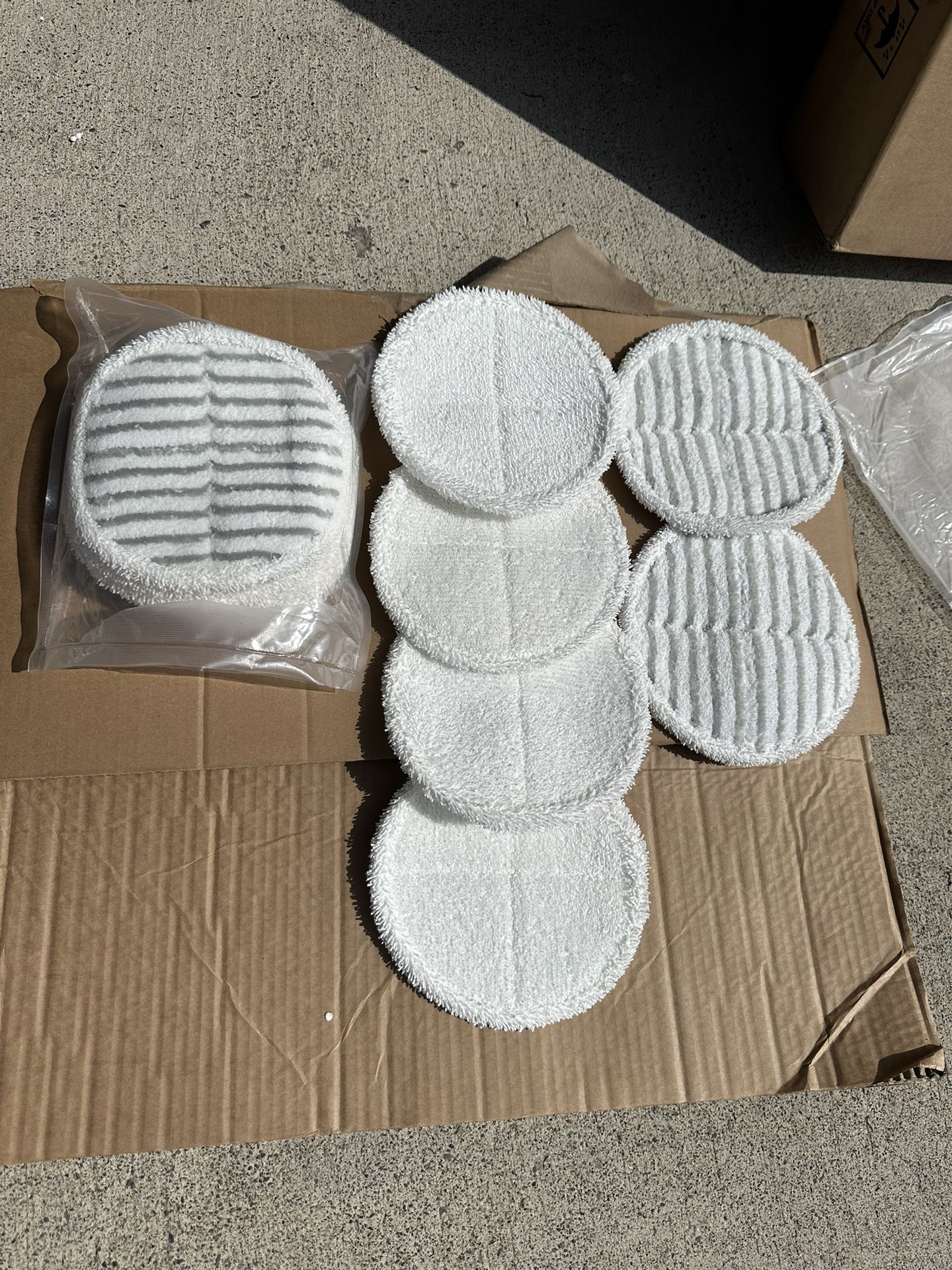 12 pack Bissell spin mop replacement pads, 4 of the striped pads and 8 of the white pads