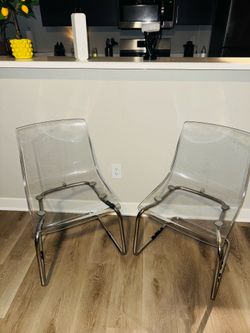 IKEA clear dining chairs.