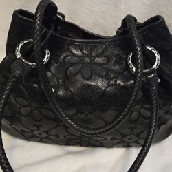 Brighton Valencia black leather shoulder bag with floral embroidery and braided straps.