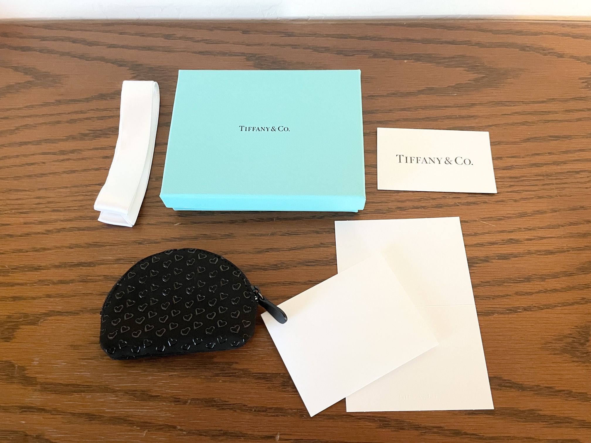 Tiffany & Co. Elsa Peretti Mini Zip Pouch in black leather with lacquered Open Hearts with Box, Ribbon, and Card