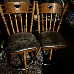 Two Swivel Barstools. Sturdy and solid. Chrome ring for feet around the bottom. Cushions have stains but not torn or ripped. Set of bar stools (2)