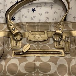 Coach gold accents with zip closure