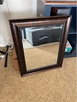 Beveled rectangular bronze mirror, 21.5” x 25.5”